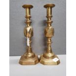 A PAIR OF BRASS KING OF DIAMONDS CANDLESTICKS