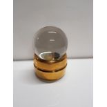 A GYPSY CRYSTAL BALL ON BRASS STAND