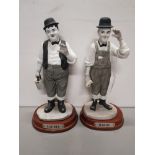 2 PARIAN FIGURES OF LAUREL AND HARDY ON WOODEN STANDS