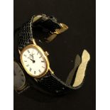LADIES BLACK LEATHER STRAPPED WHITE DIAL 18CT YELLOW GOLD BAUME MERCIER WRIST WATCH - NO BOX OR