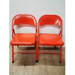PAIR OF FOLDING RED METAL CHAIRS