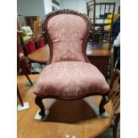 ORNATELY CARVED ROSEWOOD FRAMED NURSING CHAIR WITH PINK FLORAL UPHOLSTERING