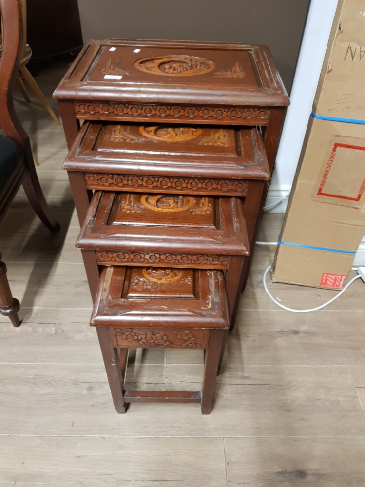 A NEST OF 4 CARVED MAHOGANY TABLES