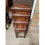 A NEST OF 4 CARVED MAHOGANY TABLES