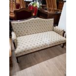 EDWARDIAN 2 SEATER MAHOGANY FRAMED UPHOLSTERED FLORAL PATTERNED CHAIR ON CASTERS