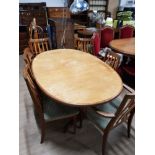 1960S BLONDE ERCOL EXTENDING OVAL DINING TABLE AND A SET OF 4 SLAT BACK DINING CHAIRS WITH 2