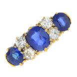 An early 20th century 18ct gold sapphire three-stone and diamond ring.