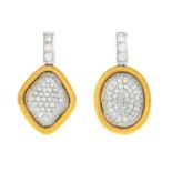 A pair of diamond earrings.