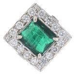 An emerald and diamond cluster ring.