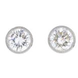 A pair of brilliant-cut diamond stud earrings.