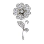 A gold diamond floral brooch.