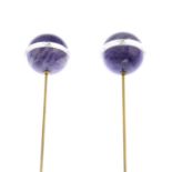 A pair of early 20th century amethyst and rock crystal hatpins.