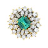 An emerald and diamond cluster ring.