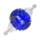 A sapphire and diamond three-stone ring.