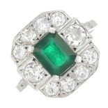 An emerald and diamond cluster ring.