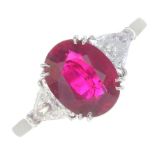 A ruby and diamond three-stone ring.