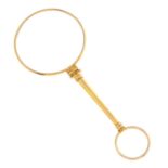 A Victorian gold magnifying glass.