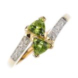 A 9ct gold peridot and diamond crossover ring.