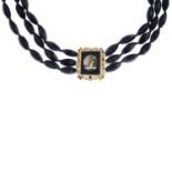 A glass bead three-row choker necklace.