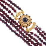 A garnet three-row necklace.