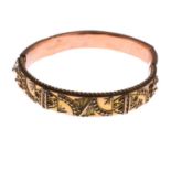 An Edwardian 9ct gold bangle.