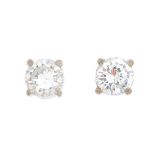 A pair of brilliant-cut diamond stud earrings.