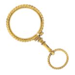 A Victorian gold magnifying glass.