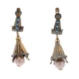 A pair of gold gem-set earrings.