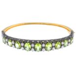 A peridot and diamond hinged bangle.