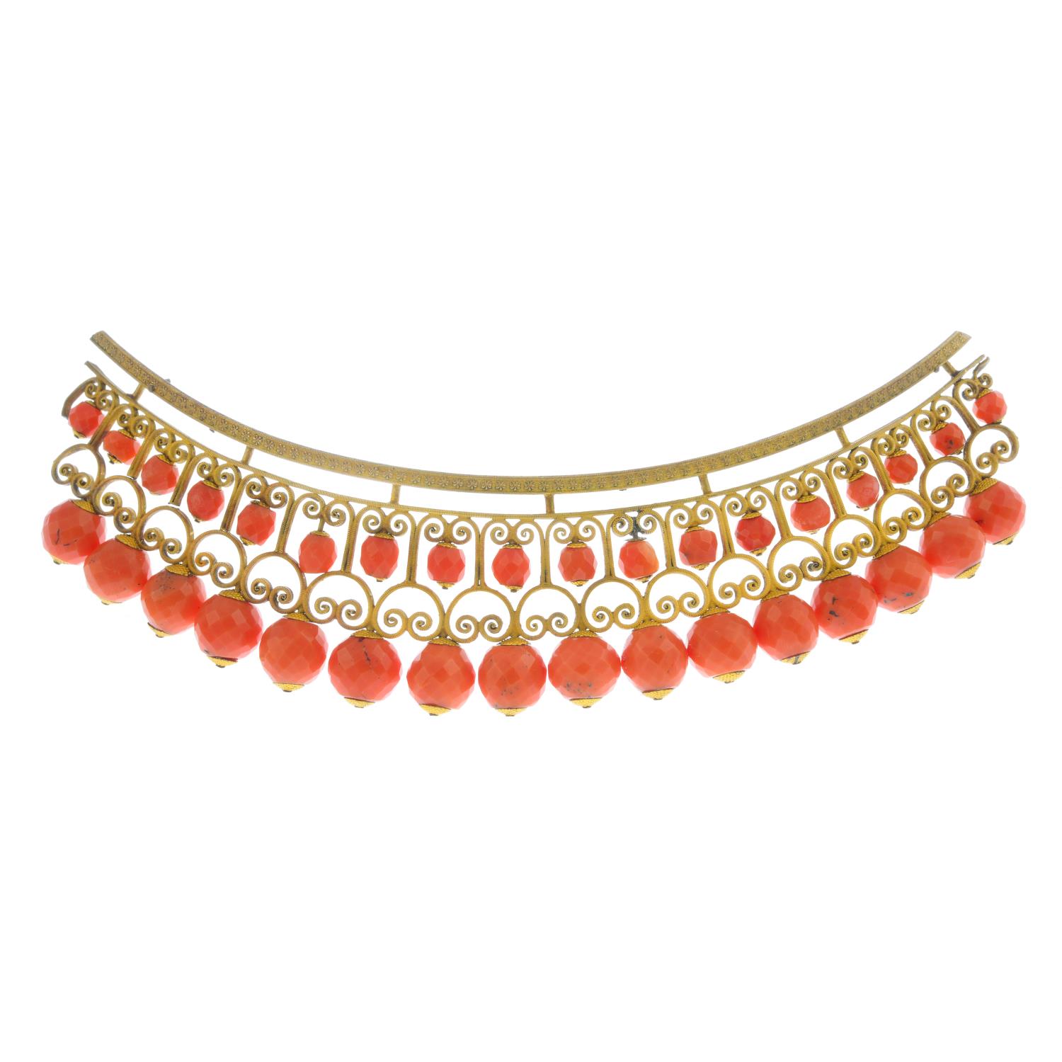 A late Georgian 15ct gold coral hair comb. Of openwork design, with faceted coral bead highlights.