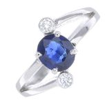 A sapphire and diamond three-stone ring.