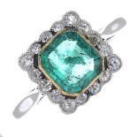 A mid 20th century platinum emerald and diamond ring.