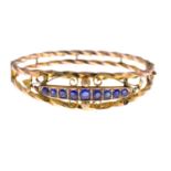 An early 20th century gold sapphire bangle.