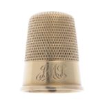 An early 20th century 15ct gold thimble.