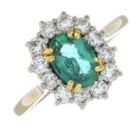 An 18ct gold emerald and diamond cluster ring.