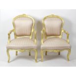 A pair of carved giltwood armchairs,