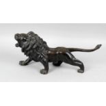 An early 20th century Japanese hollow cast bronze study of a standing lion,