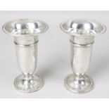 A pair of small Edwardian silver vases,