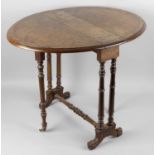 A small Victorian walnut veneered oval topped drop leaf Sutherland table,