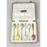 A 1930's cased set of six silver and enamel coffee spoons,