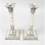 A pair of Edwardian silver mounted Corinthian capital candlesticks,