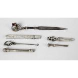 A selection of novelty items comprising a small silver bookmark,