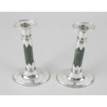 A pair of late Victorian silver mounted candlesticks,