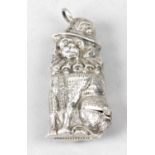 A novelty vesta case modelled as a seated spaniel wearing a plumed hat and collar ruff,