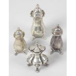 Four silver pepper pots,