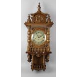 An oak cased wall clock,