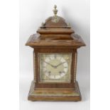 An early 20th century stained wooden cased bracket style mantel clock,