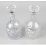 A mid-twentieth century matched pair of silver mounted glass decanters,