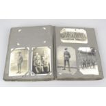 An early 20th century postcard album containing a selection of monochrome and colour postcards,