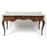 A reproduction French Kingwood veneered ormolu mounted bureau plat,